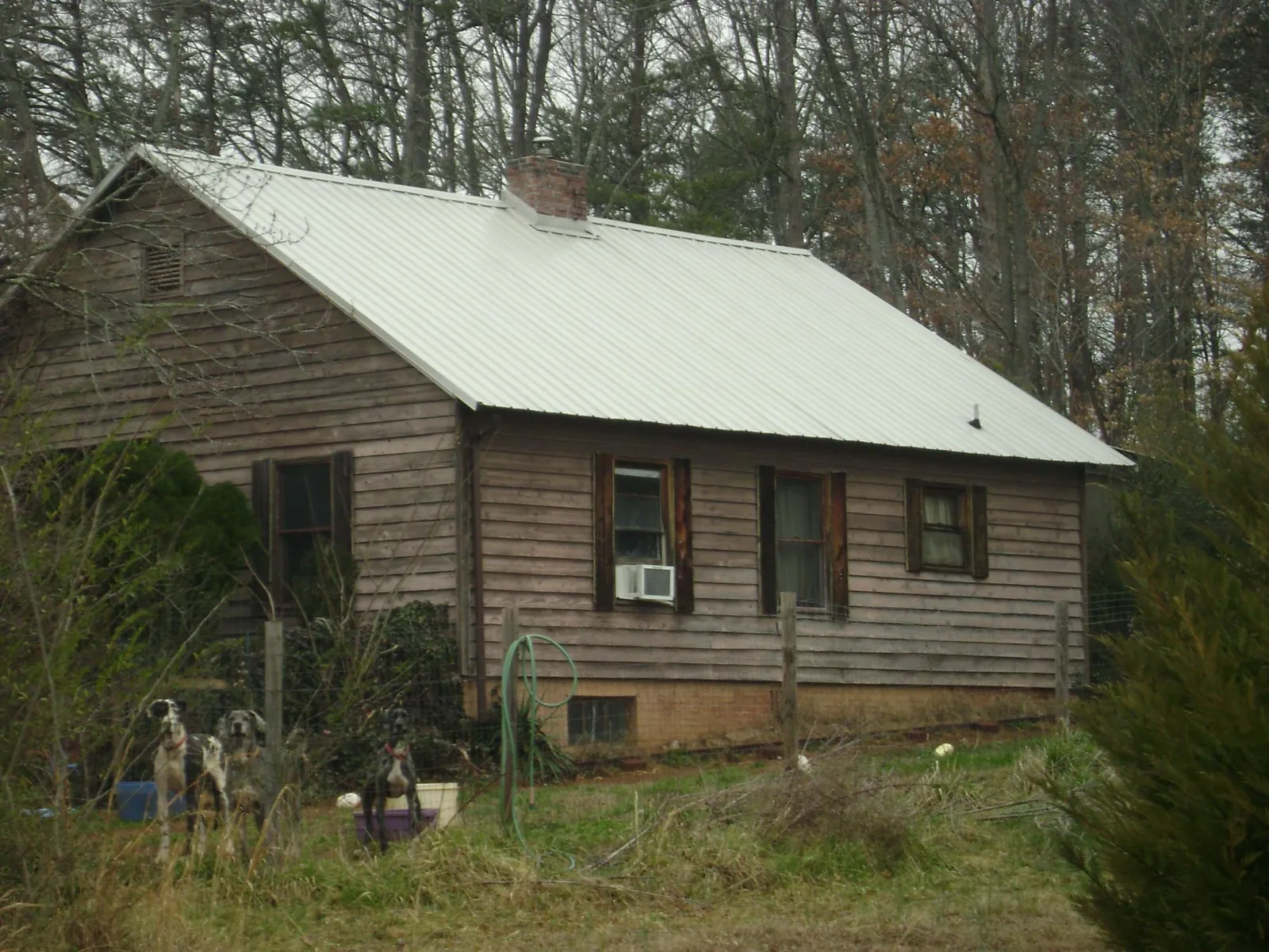 White metal roof on an old wood sided farmhouse, from a Metal Roof Installation job in Miltona